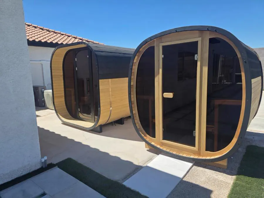 Two cedar barrel saunas beside the pool