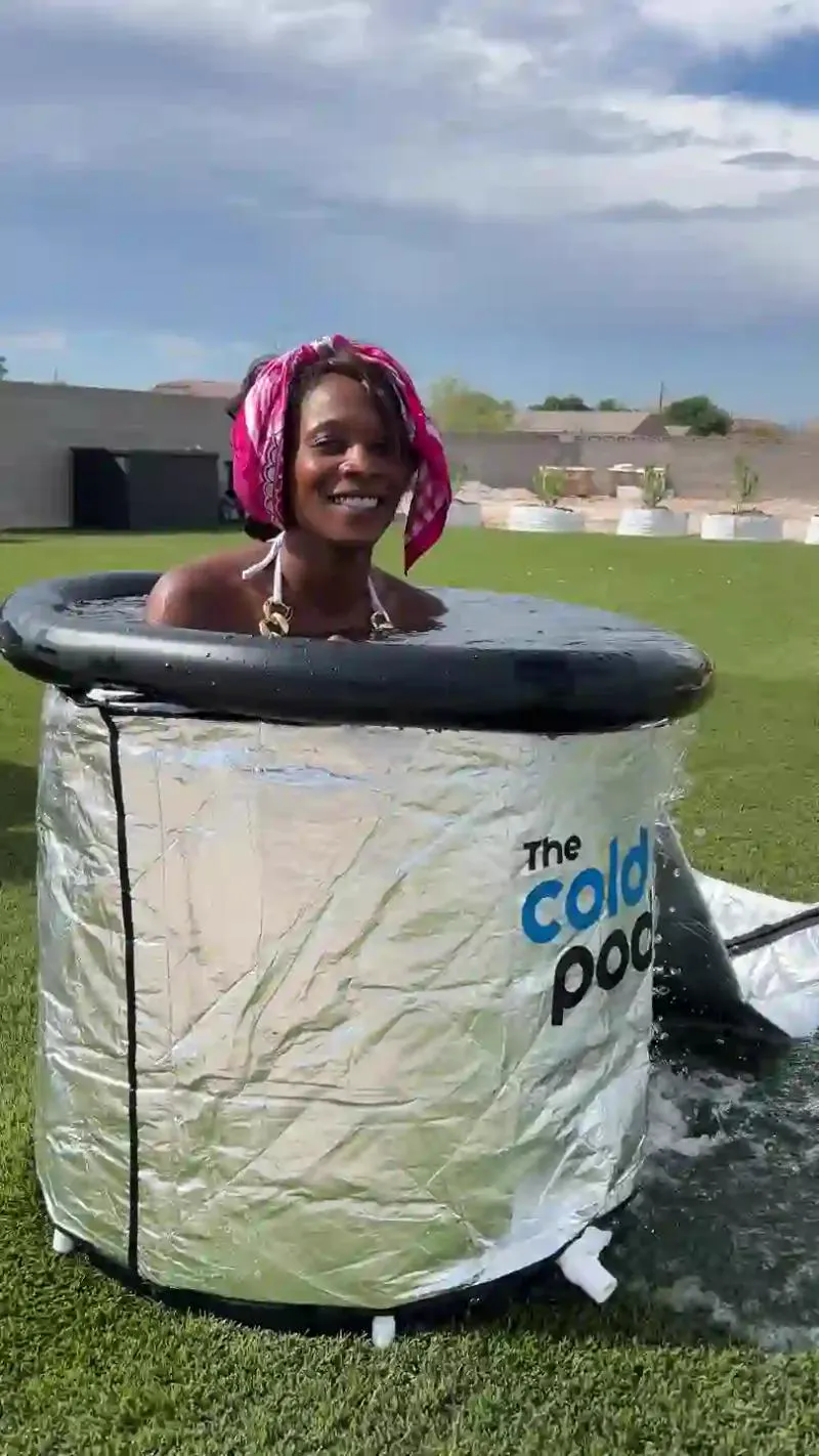 A guest in a cold plunge at the wellness social