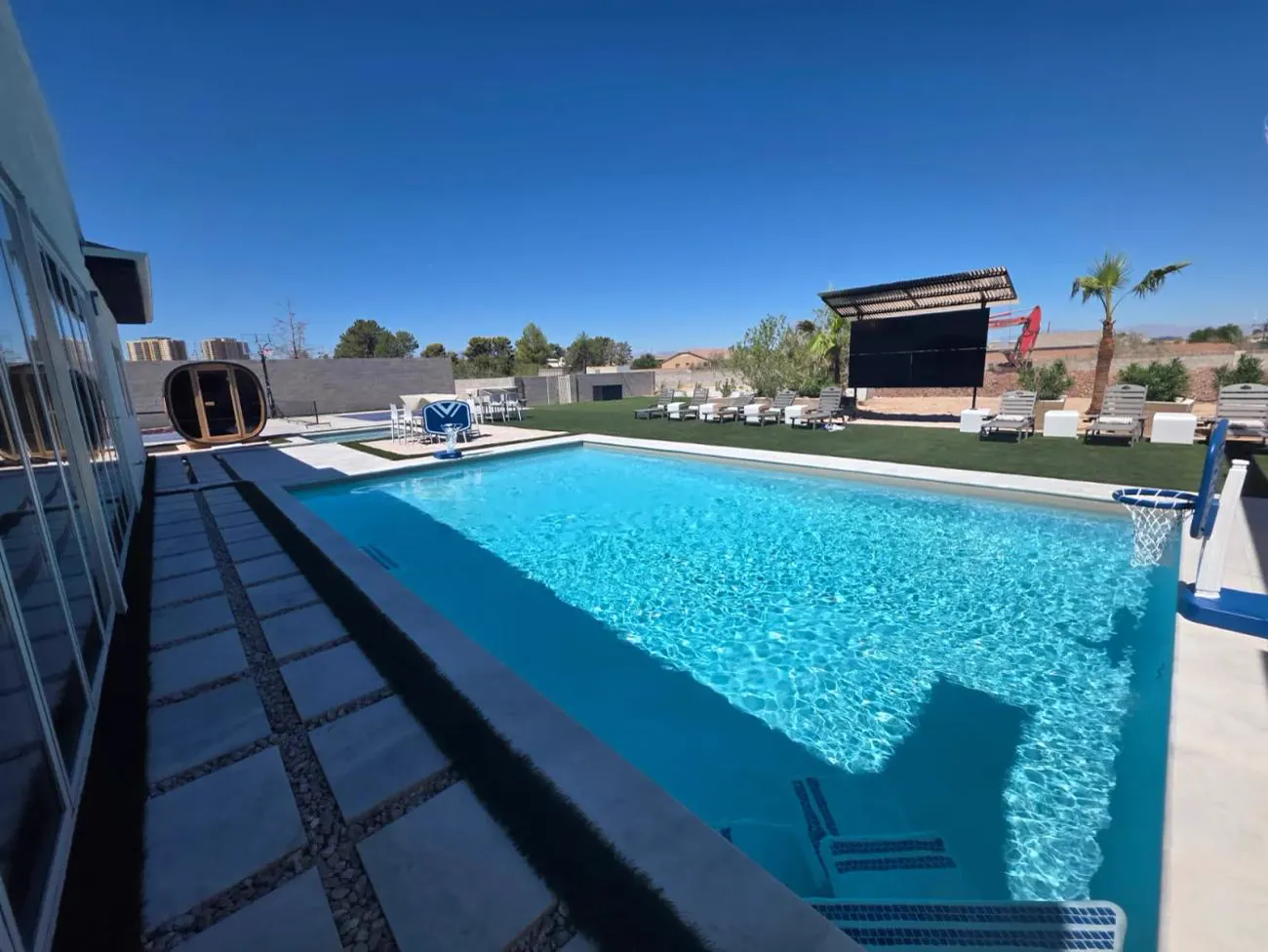 Resort-style pool with an outdoor theater screen