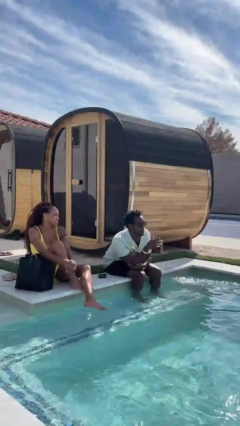 Guests relaxing poolside beside the cedar saunas
